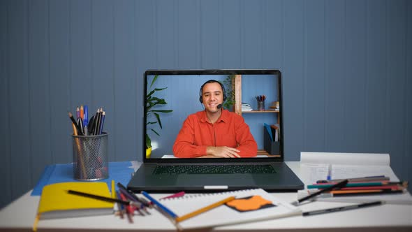 Young Man in Headset with Microphone Holding Online Meeting Conversation