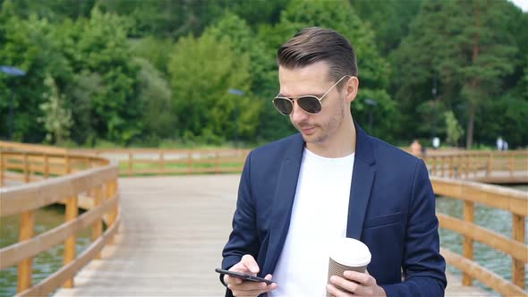 Happy Young Urban Man Drinking Coffee in European City Outdoors