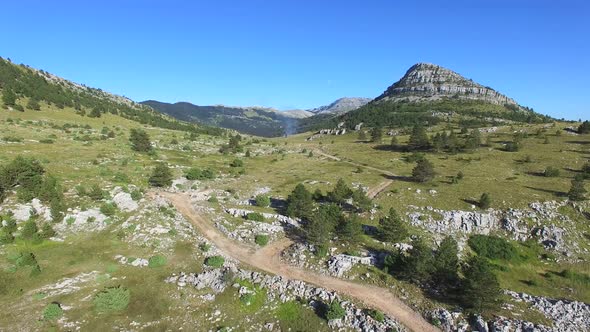 Smoke rising above Dinara hills alt