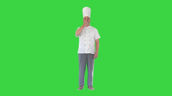 Professional Chef Man Showing Sign for Delicious on a Green Screen Chroma Key alt