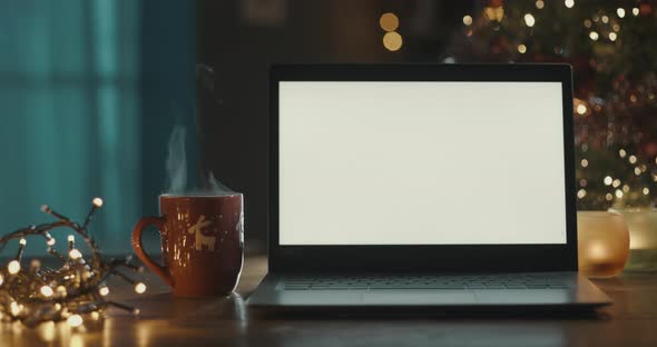 Laptop with blank screen and Christmas tree