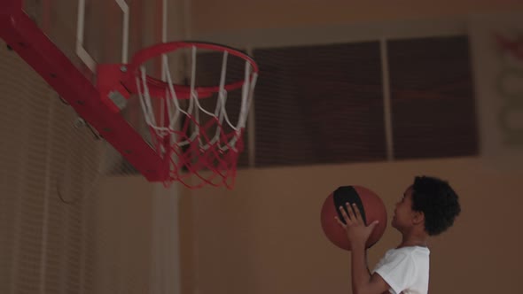 Slowmo of Happy Player Helping Son Shoot Basketball alt