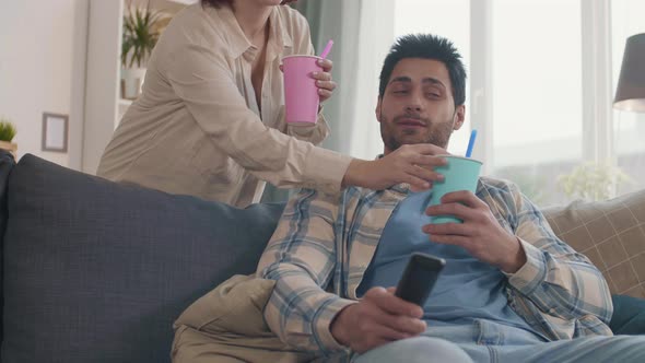 Girlfriend Bringing Soft Drinks to Boyfriend alt