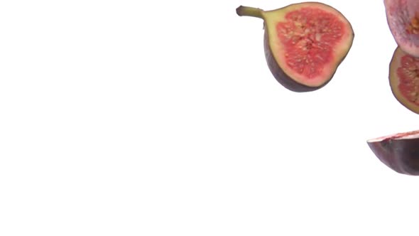 Closeup of the Sweet Fig Fruit Halves Falling Down on the White Background alt