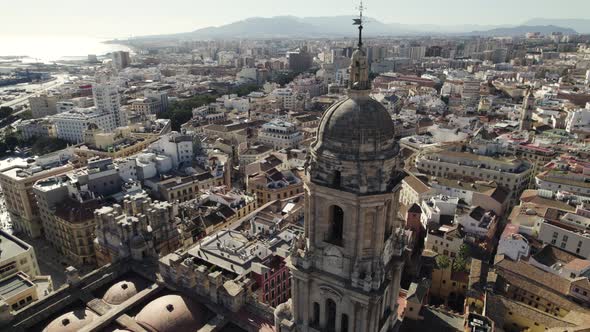 Aerial parallax of grand Malaga Cathedral tower, historic Catholic church