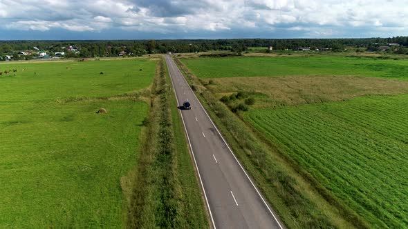 Black Car Driving On Empty Road