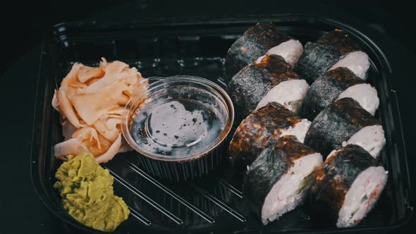 Japanese Sushi Rolls in Plastic Box is Rotating alt