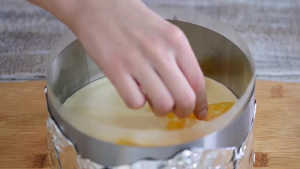Woman Makes Mousse Cake with Oranges and Jelly
