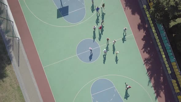  Aerial view children playing basketball on sports ground. Summer vacation holidays Sport team games