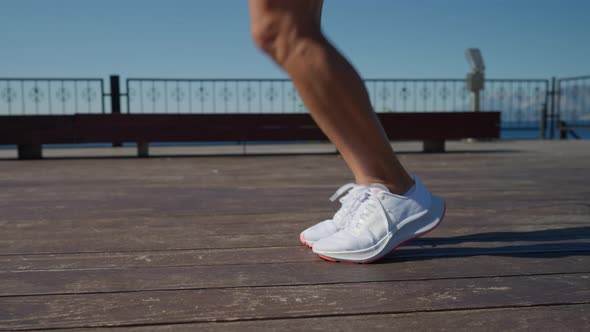 Young Woman Jumping Rope in the Rays of the Sun alt
