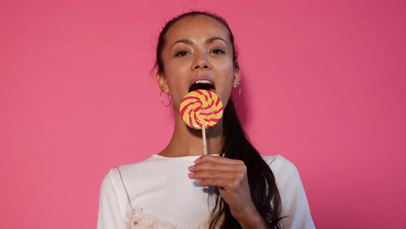 Closeup portrait of sexy girl eating lollipop alt