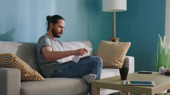 Man Is Staying Home and Drawing To Relieve Stress alt