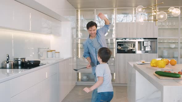 Father and Son Have Fun in the Kitchen alt