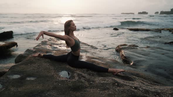Woman Doing Stretching Exercises on Beach Ocean on Background Slow Motion alt