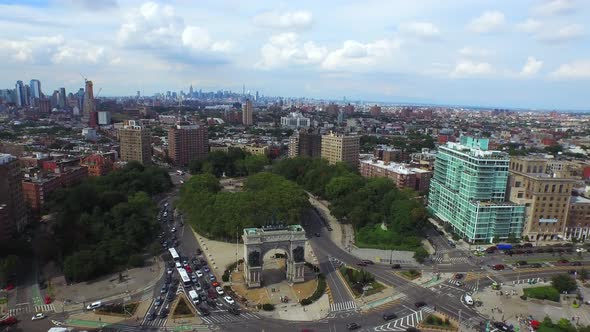 Panning aerial view of Grand Army Plaza circle in Brooklyn with NYC skyline in the distance 4K. alt