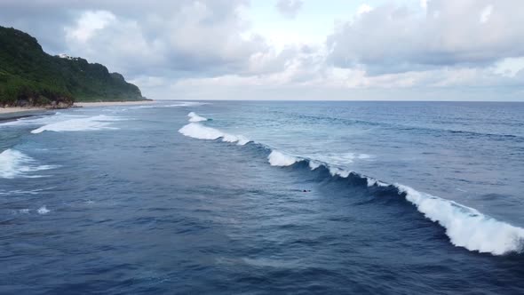 Surfer Dives Under the Wave Fluffy Clouds alt