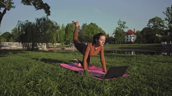 Female practicing outdoors with online trainer