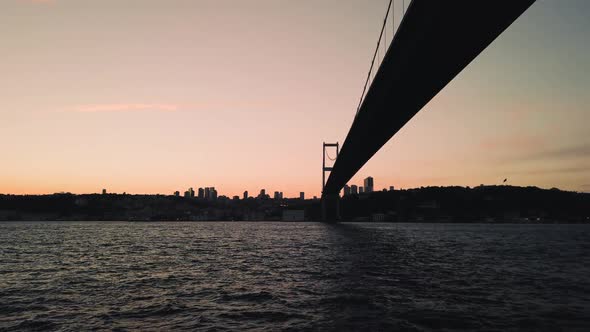 View of the Martyrs Bridge from a boating on the waters of the Bosphorus, against the background of alt