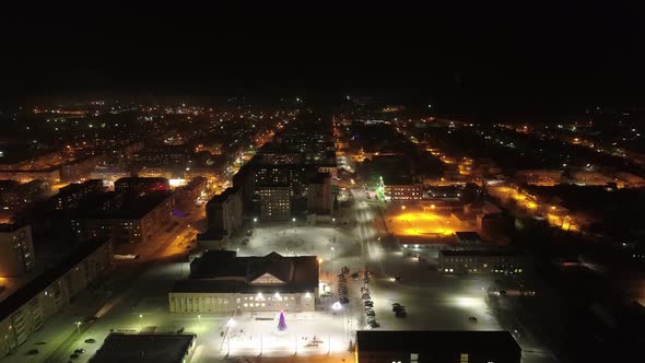 Aerial view of night Sysert city. In the shot - the streets, the house of culture, New Year tree 02 alt