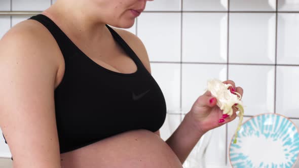 Pregnant girl cooks in the kitchen