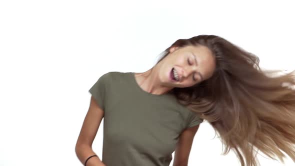 Adorable Girl in Grey Tshirt Having Fun Dancing with Her Long Luxurious Hair Fluttering in Motion alt