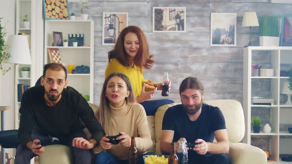 Group of Friends Trying To Beat Each Other While Playing Video Games alt