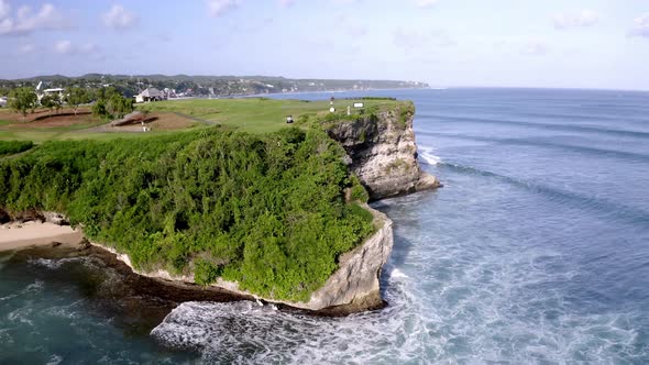 New Kuta Golf Course at Dreamland beach in Bali Indonesia near ocean cliff with waves hitting rocky alt