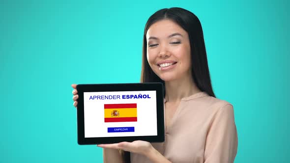 Female Holding Tablet With Learn Spanish Application, Ready to Start Course alt