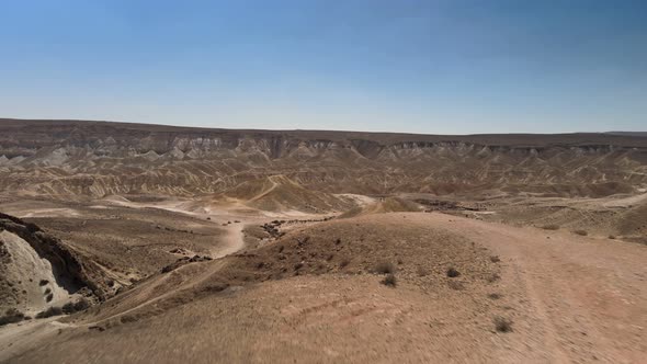 Aerial View Footage of a Man Hiking to Mountain Peak Revealing Beautiful Negev Desert Landscape