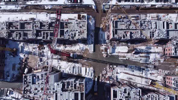 Aerial top-down view of construction site in winter season.