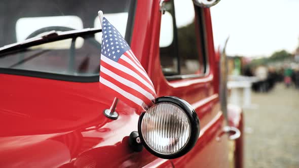Close Side View Of Red Pickup Truck With Small American Flag Waving In Slomo Slow Motion alt