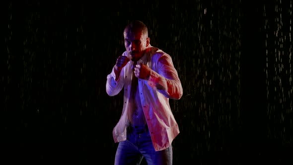 Fighter in Rain in Night Punching to Camera Slow Motion alt