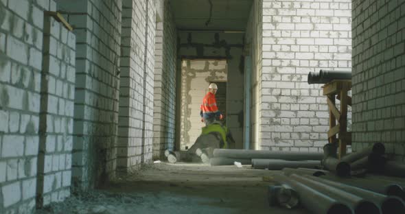 Contractor Stumbling on Pipes and Falling Behind Colleague alt