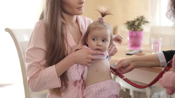 Beautiful Mother with Daughter Making Appointment to Doctor