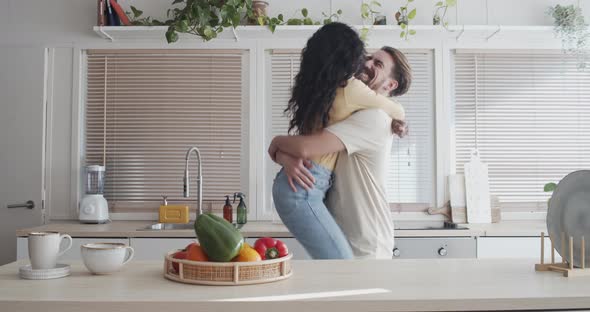 Heterosexual Multiethnic Couple Embracing in an Apartment  alt
