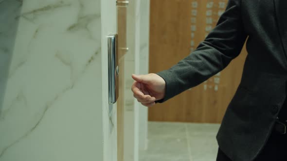 Slow Motion Closeup of Man's Hand Pressing Elevator Button in Business Center alt