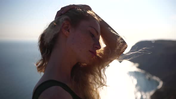 Close Up Shot of Beautiful Young Caucasian Woman with Curly Blond Hair and Freckles Looking at alt