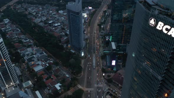 Aerial Tilting View Following Busy Multi Lane Traffic Into the Modern City with Tall Skyscrapers in alt