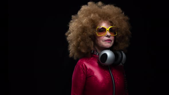 Senior Woman Dancing in Disco with Headphones alt