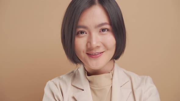 Close up shot of confident Asian business woman happy looking at camera isolated