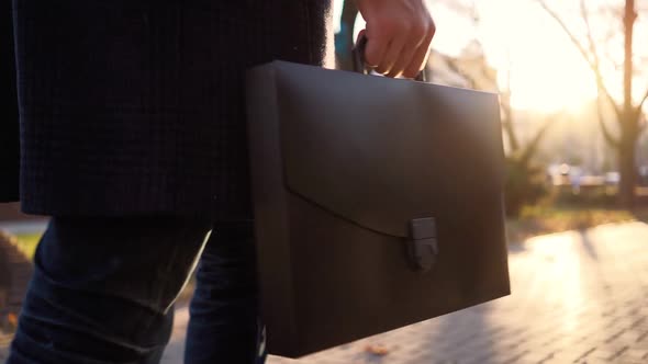  Business Man with Diplomat in His Hands Walks After Work in Sunset Light City alt