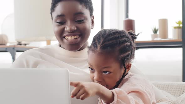Portrait African Mother Woman and Afro American Black Little Girl Daughter Child Sitting Together at alt