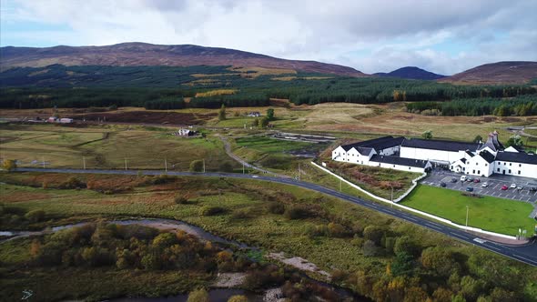 Aerial Panning of a Distillery and Farmland in Dalwhinnie Scotland alt