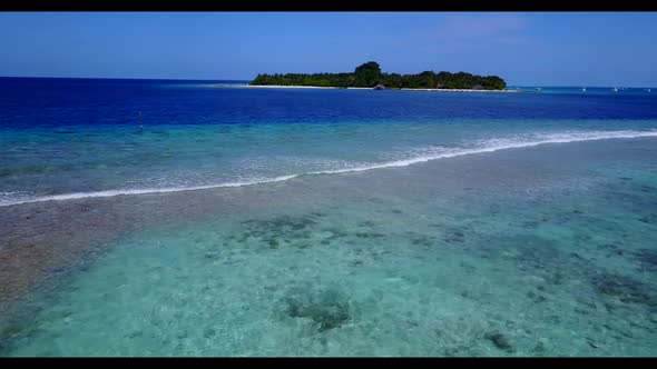 Aerial flying over landscape of tranquil island beach holiday by blue ocean and white sand backgroun alt