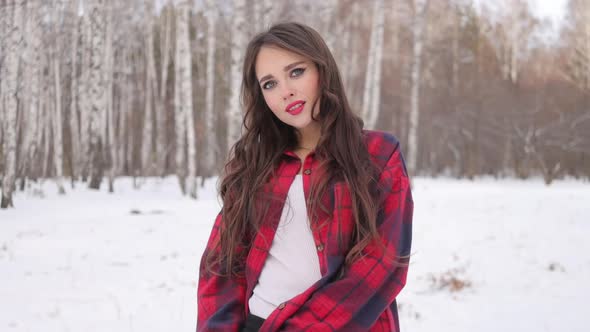 Woman with Red Lips in Winter Forest