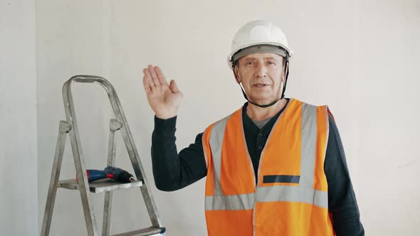 Male Construction Worker Vlogger Shows Renovation in Apartment Recording Video for Followers alt