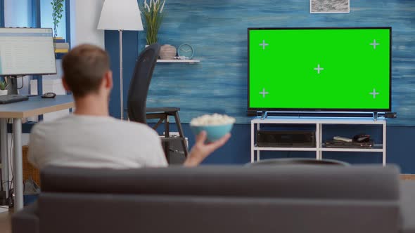 Man Relaxing on Couch Looking at Green Screen on Tv Watching Movie ...