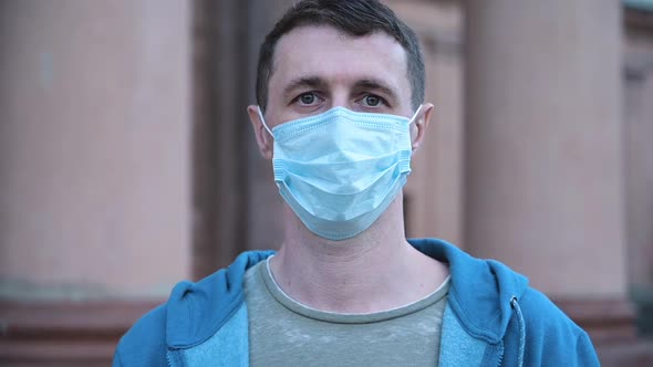 Portrait of a Young Man Wearing Protective Mask on Street