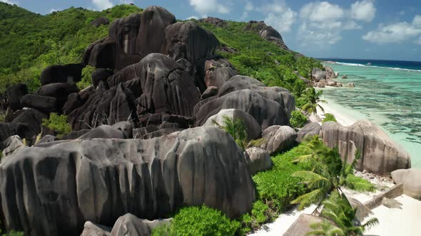 Aerial dolly lift up over the famous granite black mountain, La Digue alt