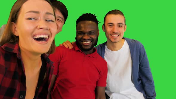 Multiracial Group of Young Friends Making Selfie and Laughing on a Green Screen Chroma Key